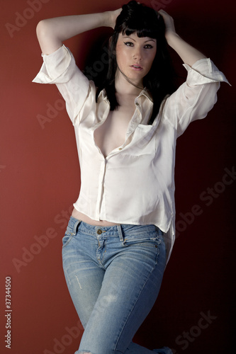 Young woman in casual clothes leaning against wall