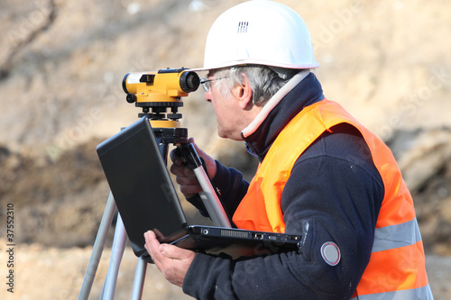 A land surveyor using an altometer