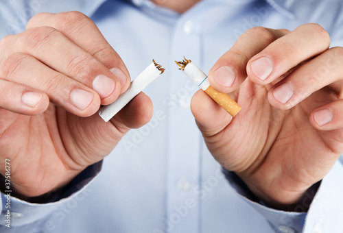 Quit smoking, human hands breaking up cigarette