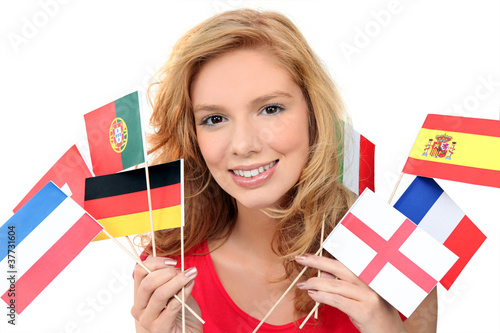 girl holding a bunch of national flags