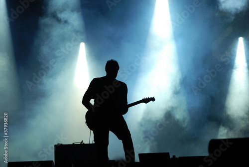 silhouette of guitarist at concert