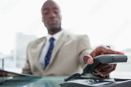 Businessman hanging up