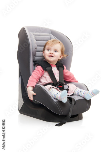 girl sitting on child's car seat