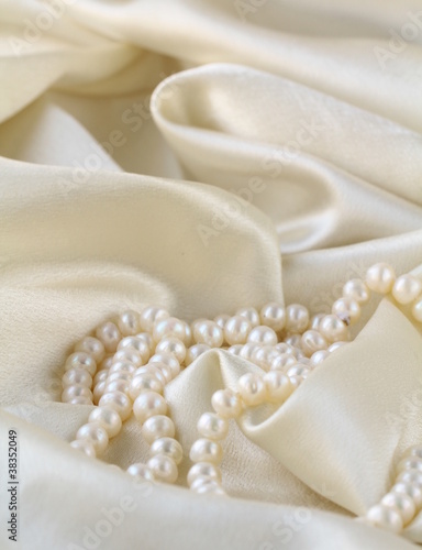 Pearls a necklace on a silk fabric