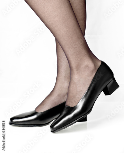 Woman wearing black shoes on white background