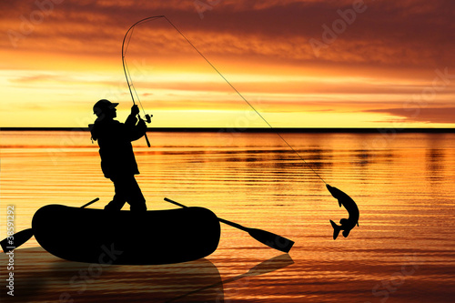 Fishermen in boat at sunset