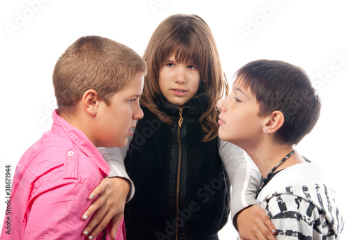 Teenage girl and two angry teenage boys that want to fight