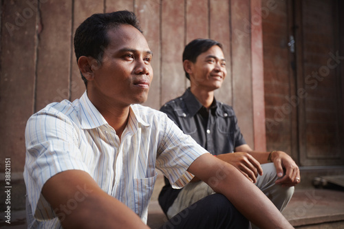 Two young Asian men smiling