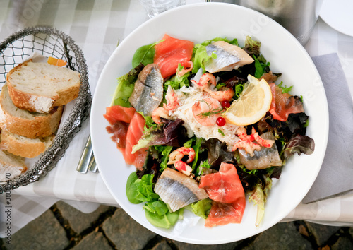 lunch - plate of big salad with with salmon and herring