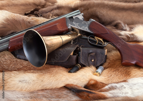 Closeup of hunter gun on fur background