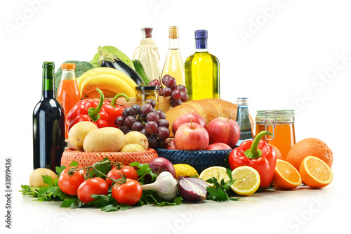 Composition with groceries and basket isolated on white.