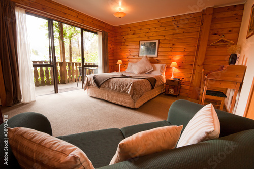 Interior of mountain wooden lodge bedroom