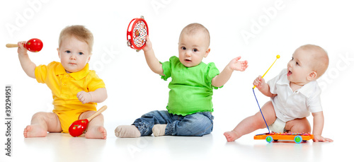 Children playing with musical toys. Isolated on white background