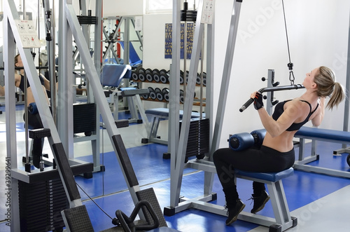 Woman working out on lat machine