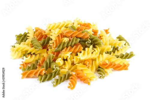 Uncooked pasta fusilli in different colours, white background
