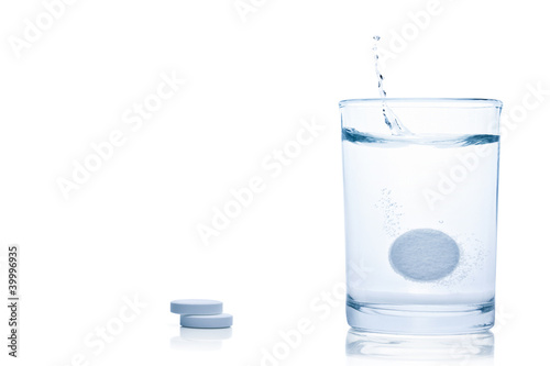 Fizzy pill splash in a glass of water.