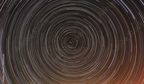 Cumulative time lapse of star trails in night sky.