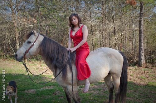 woman in red dress riding a horse bareback