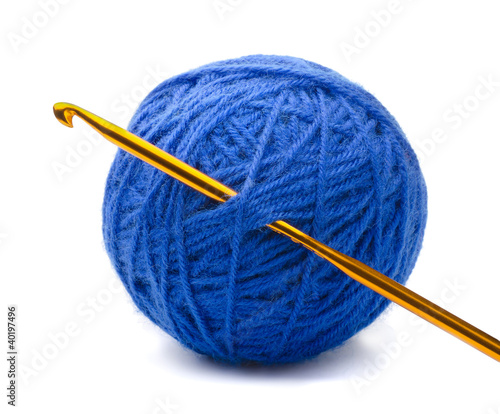 Ball of blue yarn and crochet hook