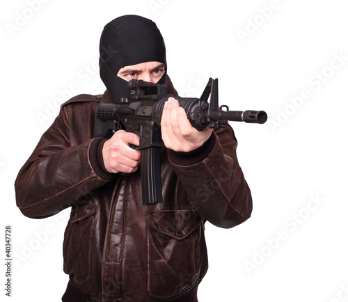 Caucasian terrorist with balaclava and assault rifle isolated white background