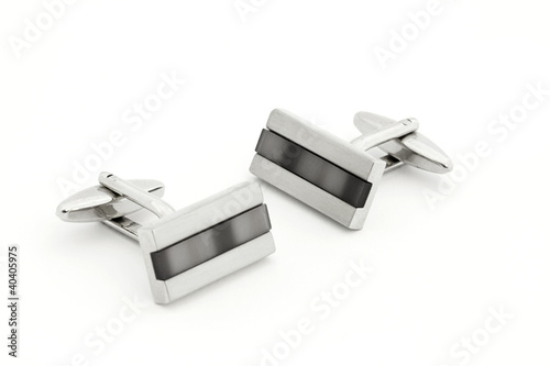 Pair of silver cuff links over white