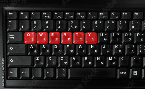 Computer laptop keyboard showing qwerty letters colored in red