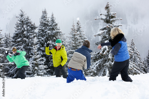 Group Of Young Friends Having Snowball Fight On Ski Holiday In M