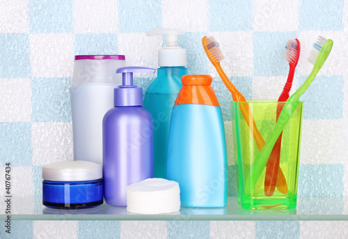 Shelf with cosmetics and toiletries in bathroom