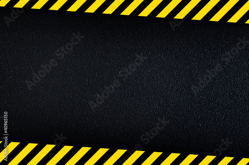 Dark background with yellow caution stripes