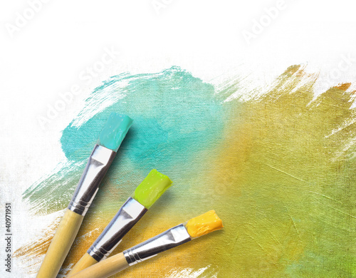 Artist brushes with a half finished painted canvas