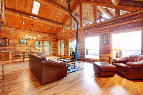 Luxury log cabin living room with leather sofa.