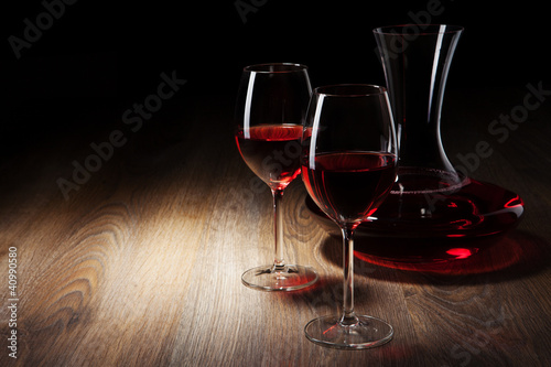 two Wine glass and decanter on a wooden table