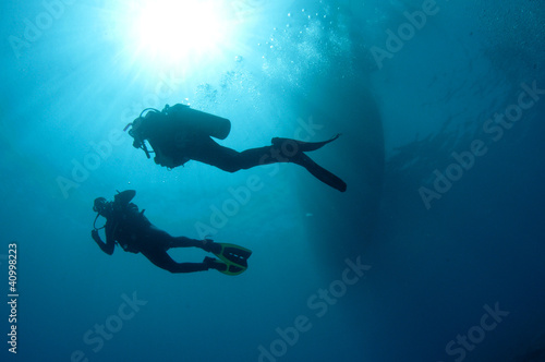 sihlouetted scuba divers