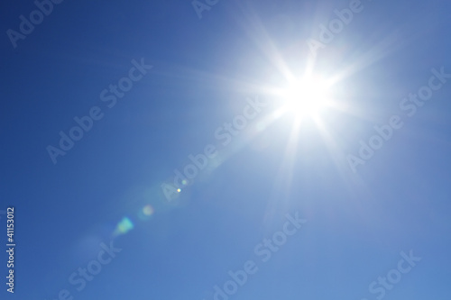 Shining sun at clear blue sky with copy space