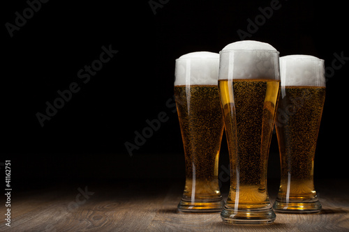 three glass beer on wooden table with copyspace