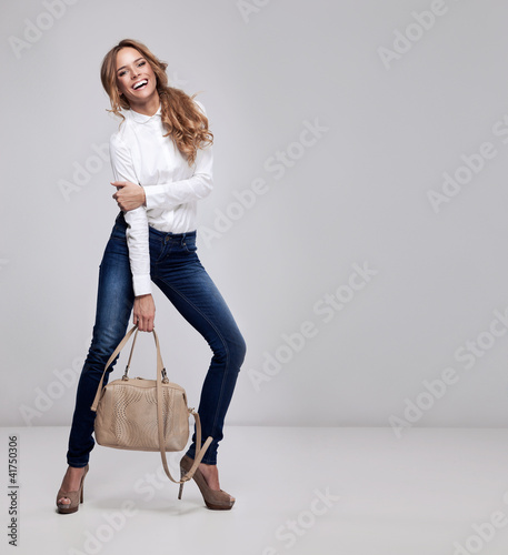Young happy woman on a grey background