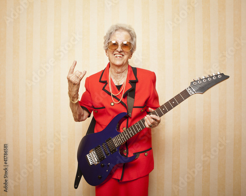 cool fashion elder lady with electric guitar