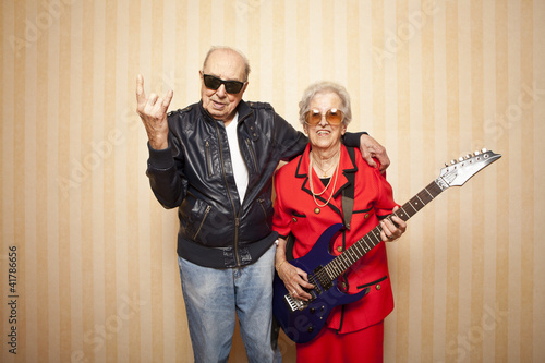 cool fashion elder couple with electric guitar