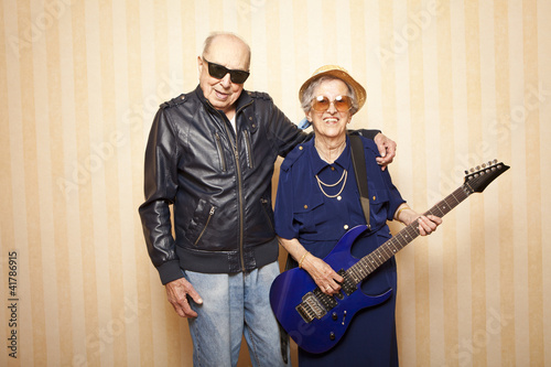 cool fashion elder couple with electric guitar