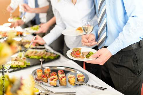 Business people take buffet appetizers