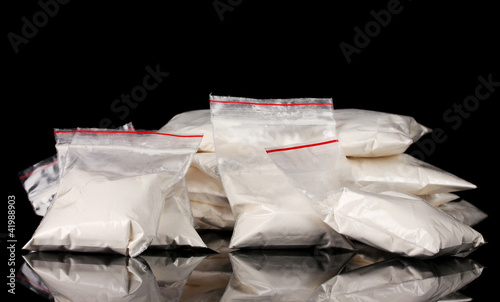 Cocaine in packages on black background