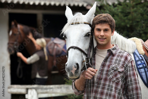 A young man with a horse.