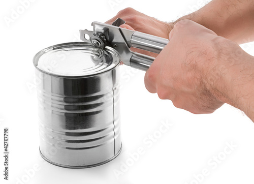 Opening tin with can opener isolated on white background