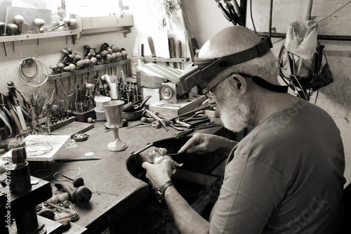 A very old jewelery shop and a jeweler in work