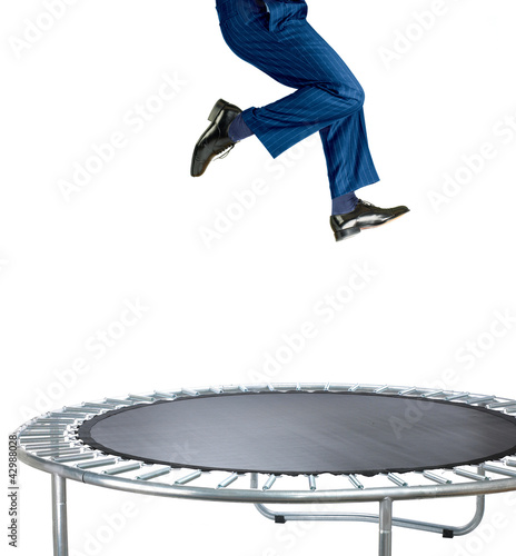 businessman bouncing on a trampoline on white