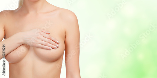 Woman controlling her breast for cancer