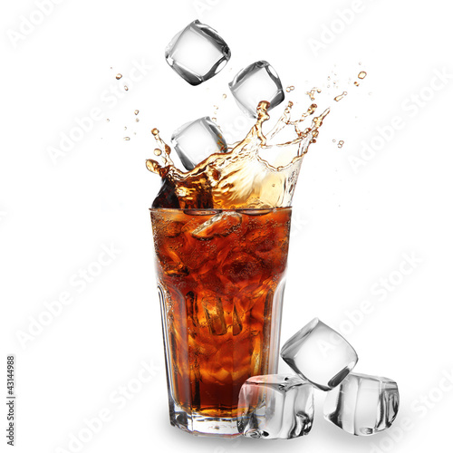 Cola glass with falling ice cubes over white