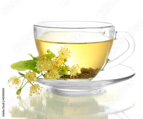 cup of linden tea and flowers isolated on white
