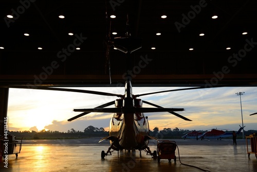 silhouette of helicopter in the hangar