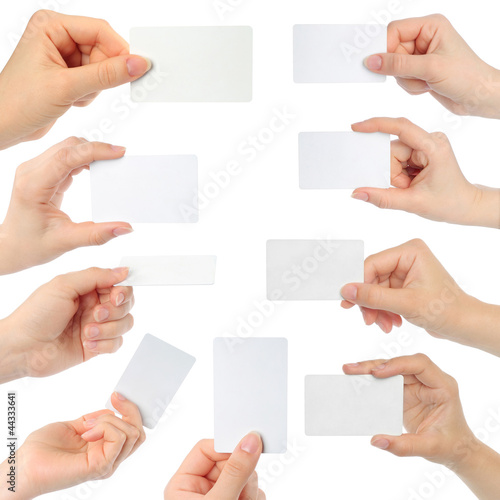 Hands hold business cards on white background